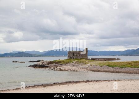 A view to a castle ruins Ballinskelligs on a beach Stock Photo