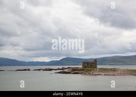 A view to a castle ruins Ballinskelligs on a beach Stock Photo