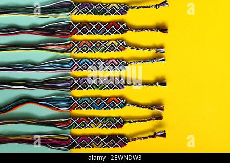 Unfinished DIY woven friendship bracelets with abstract geometric pattern. Summer accessories Stock Photo