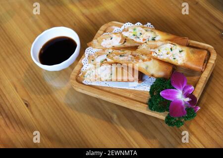 spring roll, traditional Chinese snack. A thin sheet of dough, rolled, stuffed and fried Stock Photo
