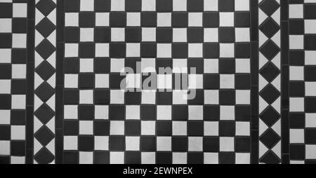 View of black and white tiled chequered Victorian floor from above Stock Photo
