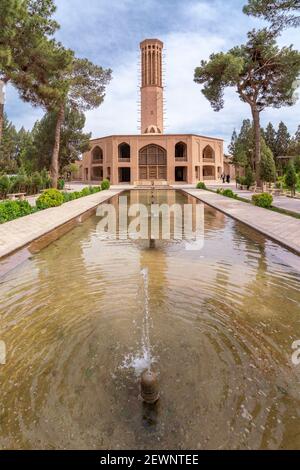 Yazd, Iran - 14.04.2019: The tallest wind tower of Iran in Dolat-Abad Garden, Yazd, Iran. Historical cooling device in beautiful persian garden. Stock Photo