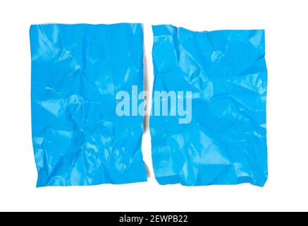 crumpled blue cardboard sheet of paper isolated on white background, a4 sheet torn in half Stock Photo