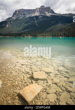 Beautiful emerald lake with dominant mountain in background,Portrait shot made at Emerald Lake, Yoho National Park, British Columbia, Canada Stock Photo