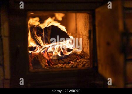 Traditional firewood oven with burning fire, Poland Stock Photo