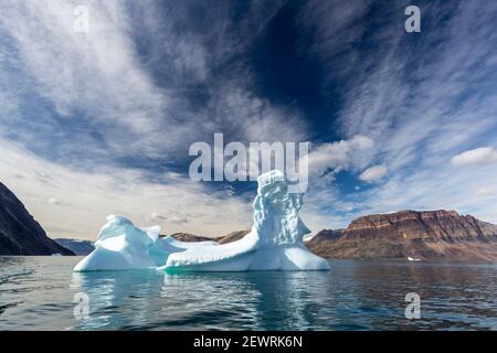 Large iceberg calved from a nearby glacier in Blomster Bugten, Flower Bay, Greenland, Polar Regions Stock Photo