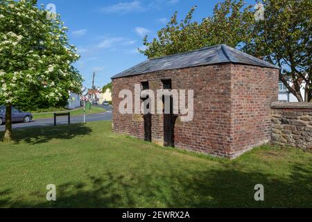 The historic old  brick built village lockup in Hunmanby, North Yorkshire Stock Photo