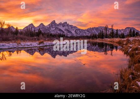 Sunset and reflection of Teton Range in Snake River at Schwabacher's Landing, Grand Teton National Park, Wyoming, United States of America Stock Photo