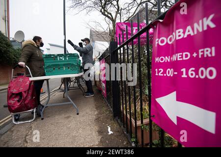 People queue at the Ringcross Foodbank, in north London, where vension from wild deer, which normally would have gone to some of the finest restaurants in the country, is distributed. The deer population has risen to over 2 million during lockdown, the highest level in over 1,000 years, largely as a result of restaurant closures. Picture date: Wednesday March 3, 2021. Stock Photo