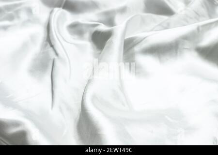 White abstract background texture of soft smooth textile silk fabric. Top view. Close up. Copy space Stock Photo