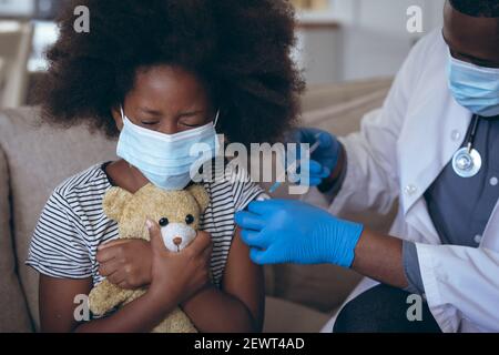 African american male doctor vaccinating his child patient Stock Photo