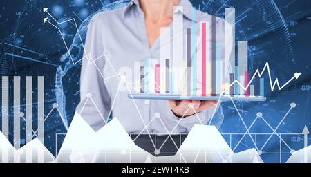 Financial data processing over woman holding tablet Stock Photo