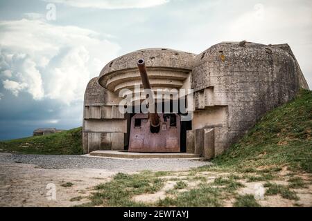 Atlantic wall concrete German World War Two gun emplacement fortification bunker naval battery at Longues-sur-mer Normandy Gold Beach France remains Stock Photo