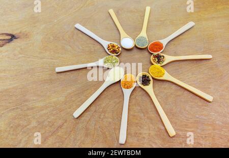 Various kind of spices in wooden bowls salt pepper garlic spice turmeric Stock Photo