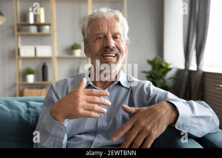 Mature man having conversation using webcamera online application Stock Photo