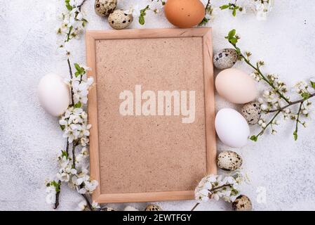 Chicken and quail eggs with blooming branch Stock Photo