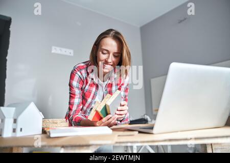 Interior designer examining paint samples on the medium-density fiberboard Stock Photo