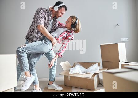 Loving couple dancing tango among carton boxes Stock Photo