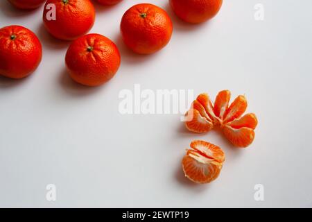 Peeled and whole mandarin oranges isolated on white background Stock Photo
