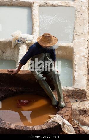 A local man takes rest beside the honeycombed earth pits at Chouara Tannery, Fes, Morocco Stock Photo