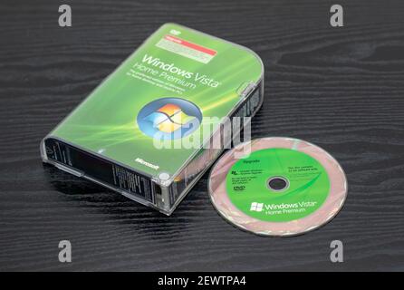 Microsoft's unreliable Windows Vista operating system which followed Windows XP.  Box and disc from the noughties on a black ash finish surface. Stock Photo