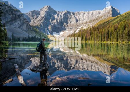 Senior hiker looking at view at Rawson Lake during summer in Kananaskis Country, Alberta, Canada. Stock Photo