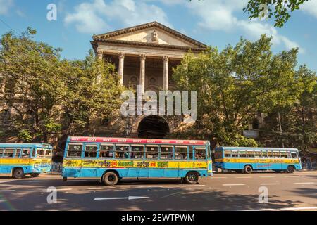 Public transport busses on city road in front of ancient heritage Government building at Dalhousie area of Kolkata Stock Photo