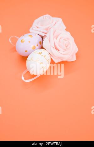 Easter composition of pink roses, colored Easter eggs and a Easter ...