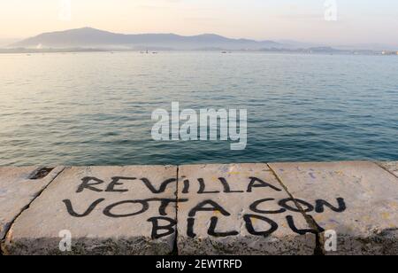 Controversial political graffiti painted on the sea wall in Santander Cantabria Spain stating Revilla voted with BILDU Basque political party with ETA Stock Photo