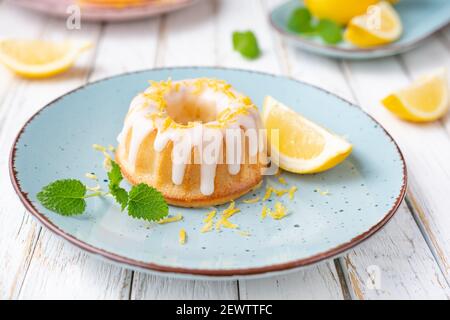 Tangy mini lemon bundt cakes topped with lemon glaze Stock Photo