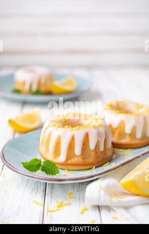 Tangy mini lemon bundt cakes topped with lemon glaze Stock Photo