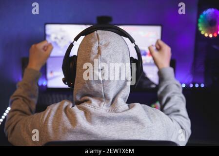 Young gamer playing video game wearing headphone Stock Photo