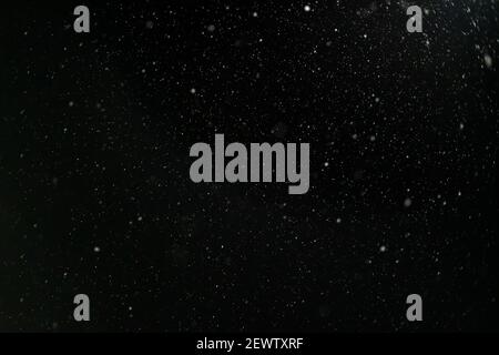 Snow against a black sky. Snow on a black background. Snow background. Stock Photo