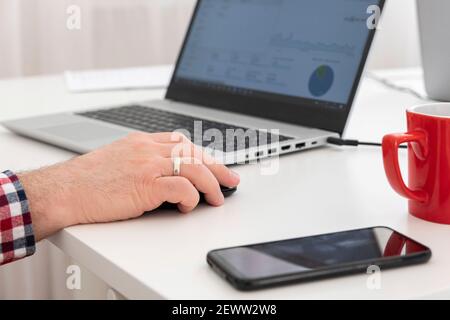 Closeup of business man's hand using computer mouse. Selective focus. Stock Photo