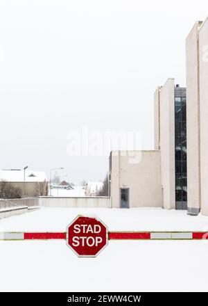 Bilingual street sign Stop or Stad in English and Gaelic Irish language on barrier in empty car park or parking lot during the 'Beast from the East' storm Emma in Killarney, County Kerry, Ireland as of March 2018. Stock Photo