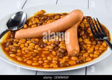 hot dogs served with baked beans on a plate Stock Photo