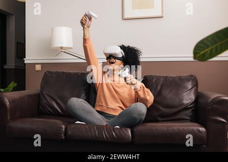 Young woman playing video games at home Stock Photo
