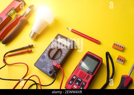 Different electrical tools on yellow background with shine Stock Photo