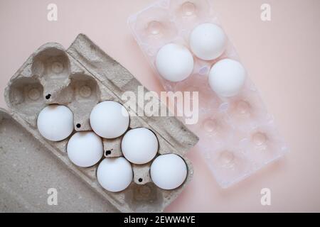 The white eggs are stored in recyclable and plastic cassettes. Waste sorting. Ecological problems Stock Photo