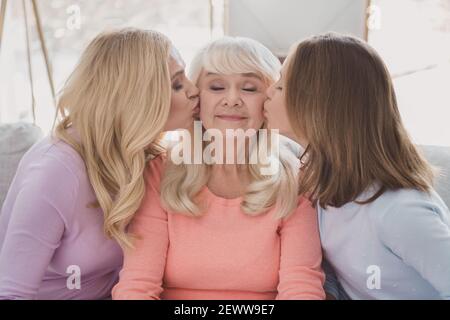 Photo portrait of mother daughter kissing lovely overjoyed granny cute family spending time on holidays Stock Photo