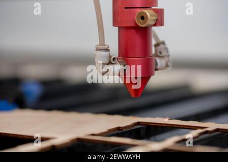 Laser CNC cutting wood. Modern machine industrial technology. Stock Photo
