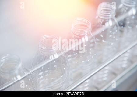 Production of PET plastic bottles on conveyor belt milk and water factory. Stock Photo