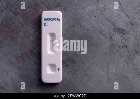 Covid-19 lateral flow test kit on grey surface Stock Photo