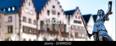 Justitia (Lady Justice) sculpture on blurred Römer background, Frankfurt am Main, Germany Stock Photo