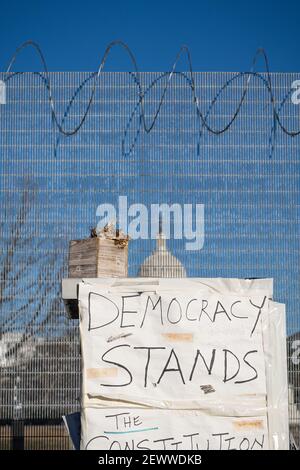 WASHINGTON D.C., UNITED STATES - Feb 25, 2021: Washington, D.C., USA- February 24th, 2020: A sign reading 'democracy stands' outside the fencing surro Stock Photo