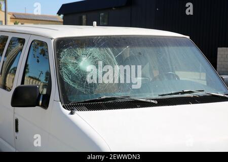 Broken Windshield. A Badly Broken Windshield on an old white panel truck. Broken Windshields are dangerous and illegal to drive with. Window Repair Co Stock Photo
