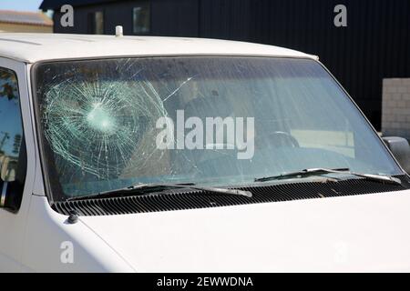 Broken Windshield. A Badly Broken Windshield on an old white panel truck. Broken Windshields are dangerous and illegal to drive with. Window Repair Co Stock Photo