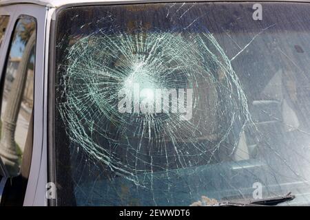 Broken Windshield. A Badly Broken Windshield on an old white panel truck. Broken Windshields are dangerous and illegal to drive with. Window Repair Co Stock Photo