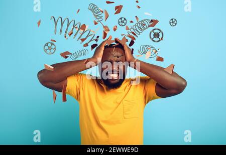 Boy with stressed and exhausted expression is desperate. cyan background Stock Photo