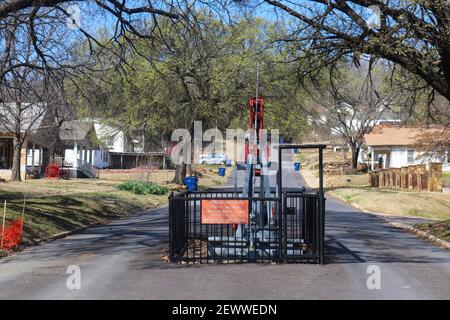 Worlds only main street oil well - pump jack in middle of street in Barnsdall Oklahoma USA 3 22 2018 Stock Photo